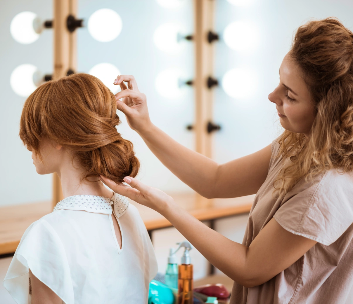 A stylist arranging a salon guest's hair